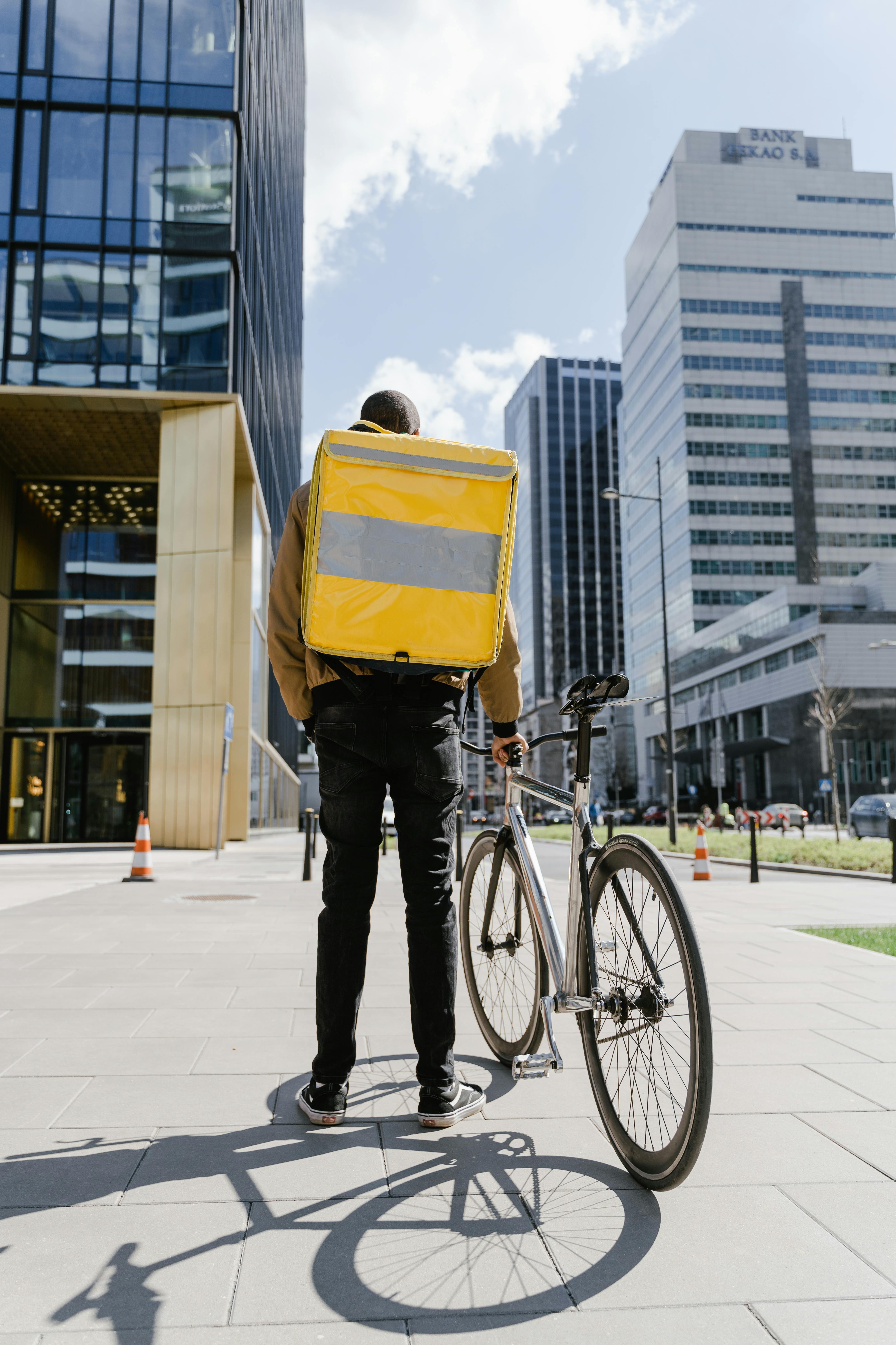 man with a bicycle and delivery bag