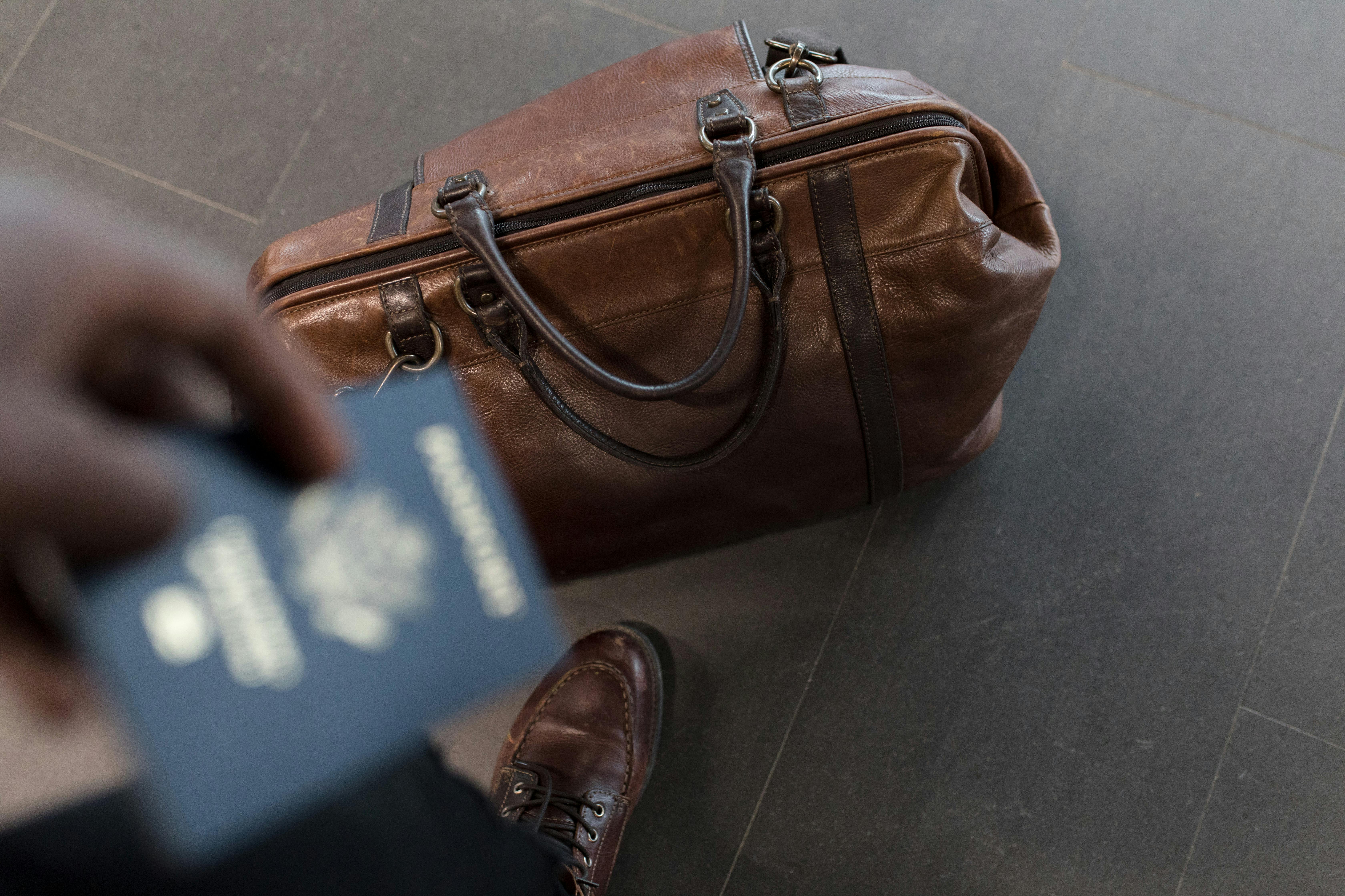 man with a passport and bag